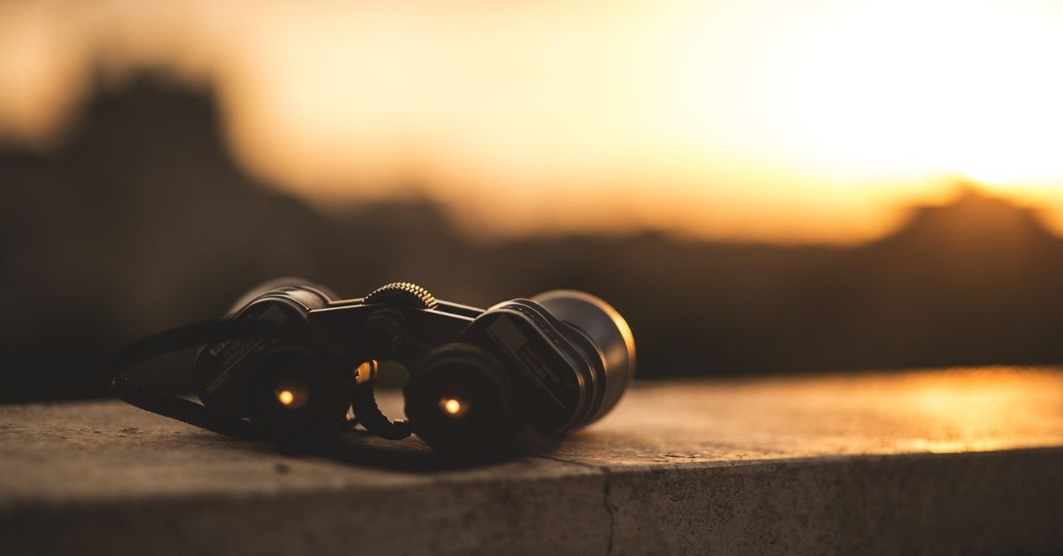 Benefits of Focusing on God - Haly Ministries (on photo: binoculars focusing on sunset)