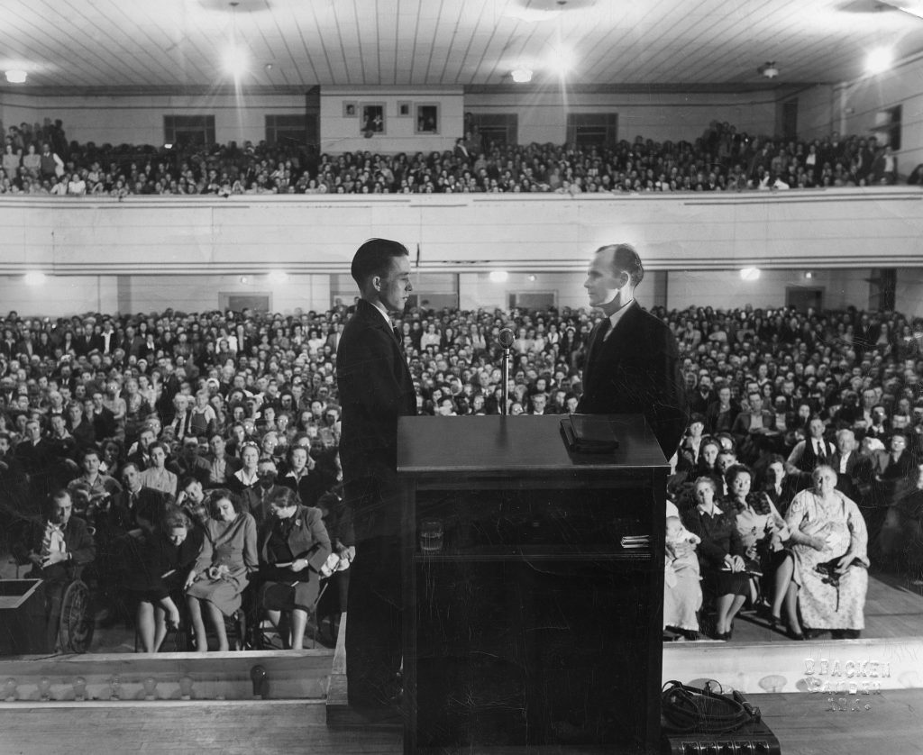 Branham Stands Before a crowd at a Campaign Appearanced as Seen in A Man Sent From God 1950