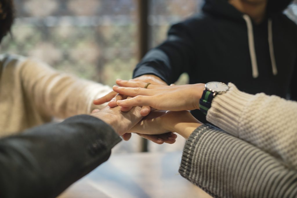 Collaborate - Five People Stretched Arms A Sign of Unity