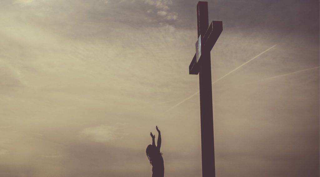 Cross and Woman Raising her Hands