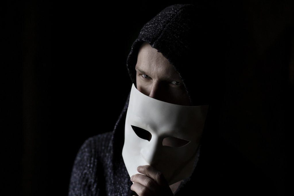 Hacker Holding Mask