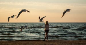 How to Change Limiting Beliefs God's Way - Haly Ministries (the woman on the beach with birds flying above)