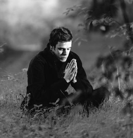 Man is Praying with Hands Folded