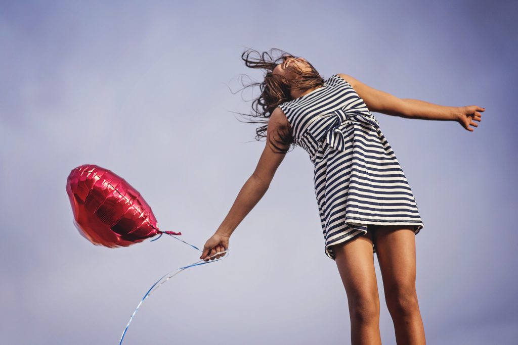 Rejoice - Happy Woman with Red Balloon