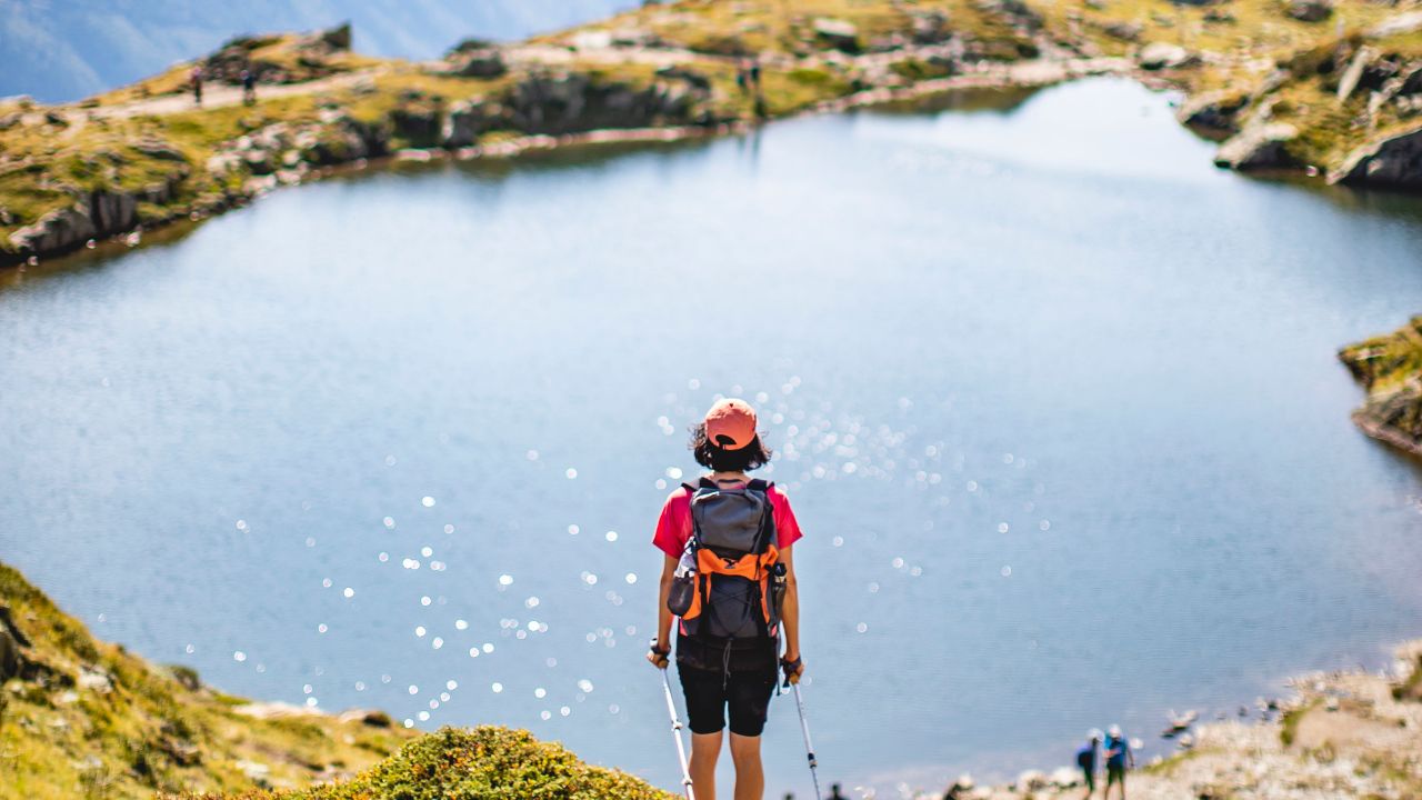 Step into a Bright Tomorrow with a New Chapter Prophetic Word - Haly Ministries. On photo: woman hiker standing by lake