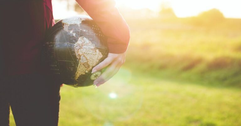 Person Holding a Globe with a Right Hand