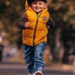 The Benefits and Results of Walking with God - Haly Ministries (on photo: a boy running in yellow jacket)