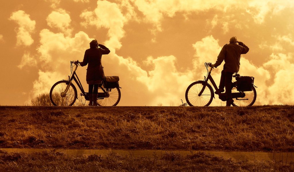 Two Cyclists Watching the Sky