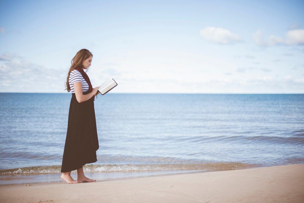 Woman Reading Bible by Sea