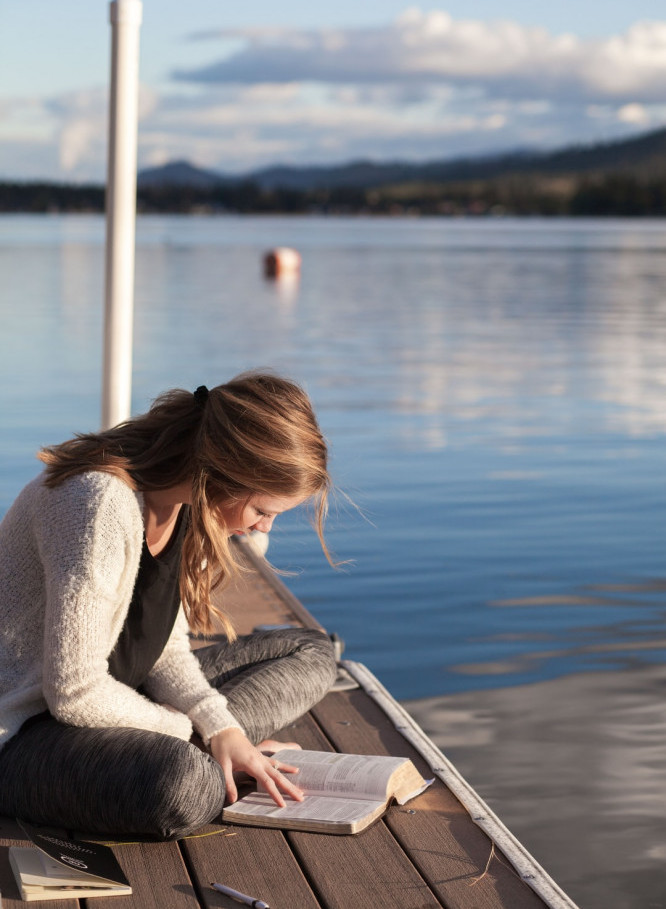 Woman Reading the Bible by the River