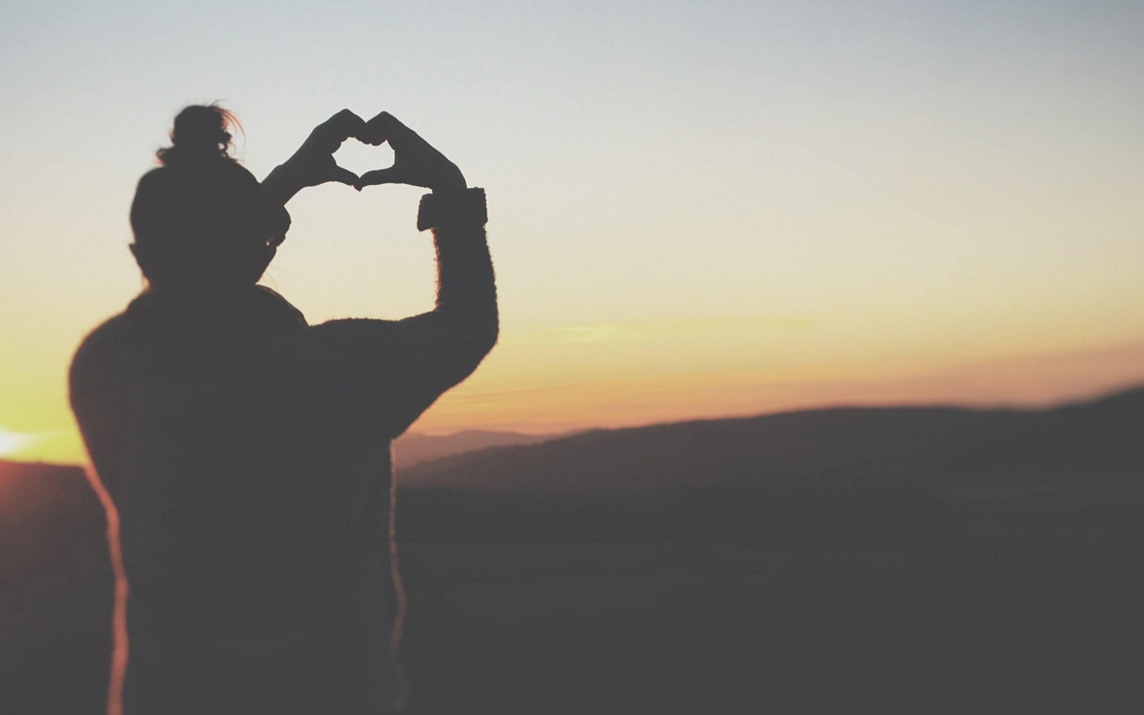 Woman Shows Heart with Hands