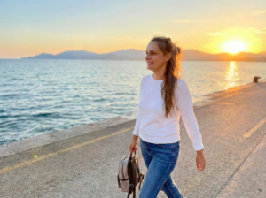 Woman walking forward on a sunlit path representing a new season and fresh start with Haly Ministries